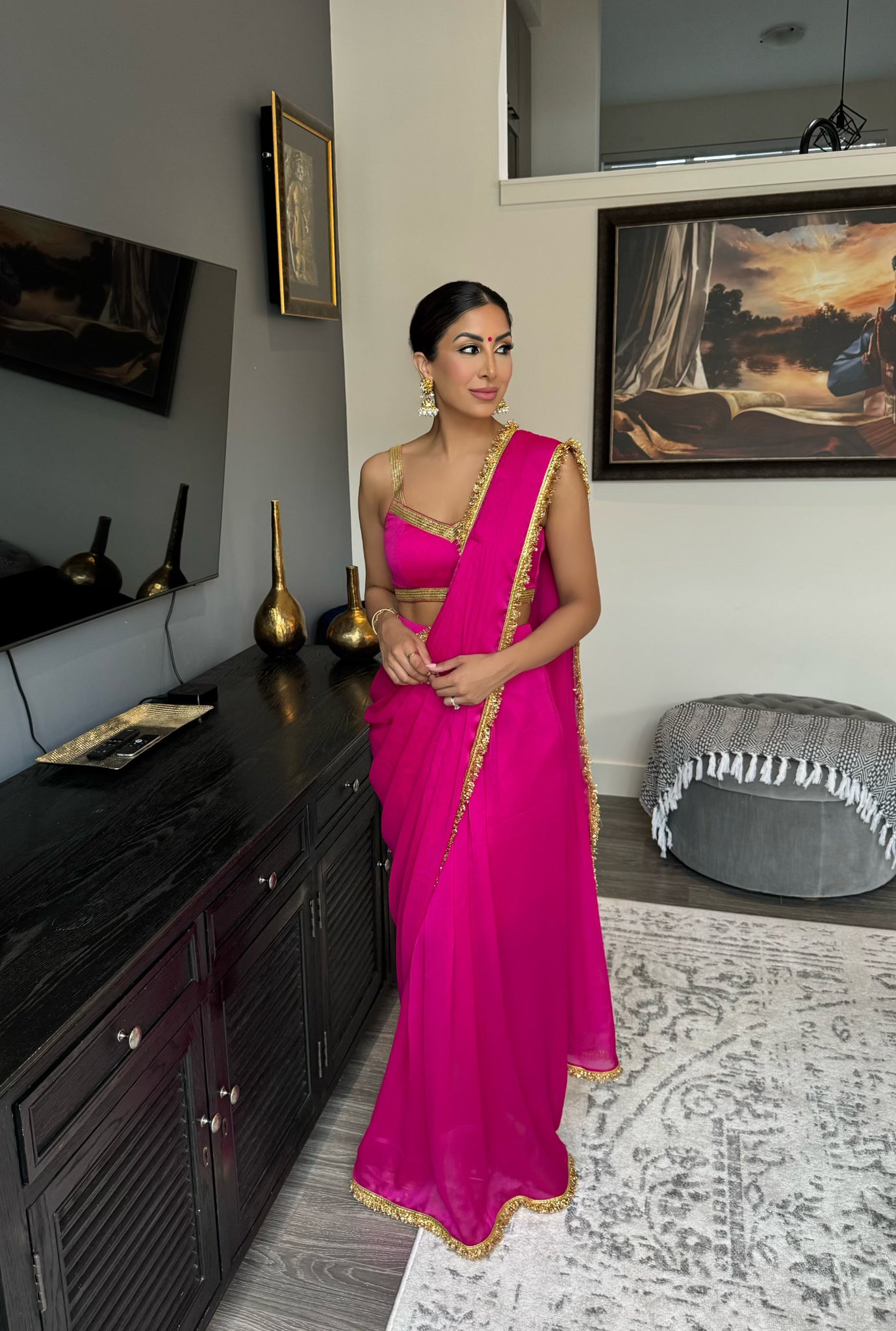 pink saree dress Sequined Blush pink Saree-Style Gown: This ensemble features a heavily embellished lavender or dusty rose fabric with intricate sequin work. The blouse has cold-shoulder sleeves adorned with delicate beaded fringe, while the